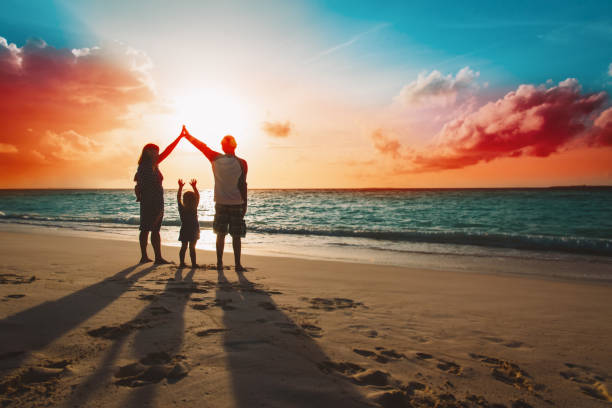 happy family with kids play at sunset tropical beach
